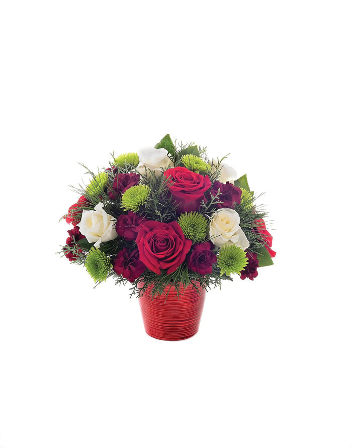 Bouquet of red, white, and green flowers in a red vase on a white background